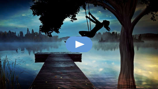 silhouette of a girl high on a swing at dusk over looking a foggy lake