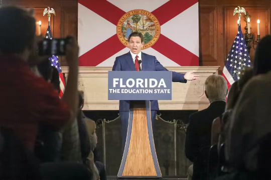 Ron De Santis at a podium that says: Florida, The Education State