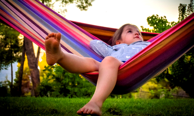 child laying back in a hammock