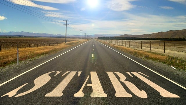 an open road with the word start written on the pavement in huge letters